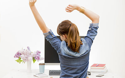 Woman-stretching-at-desk